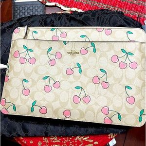 13 inch coach laptop case/sleeve, tan color with pink cherries